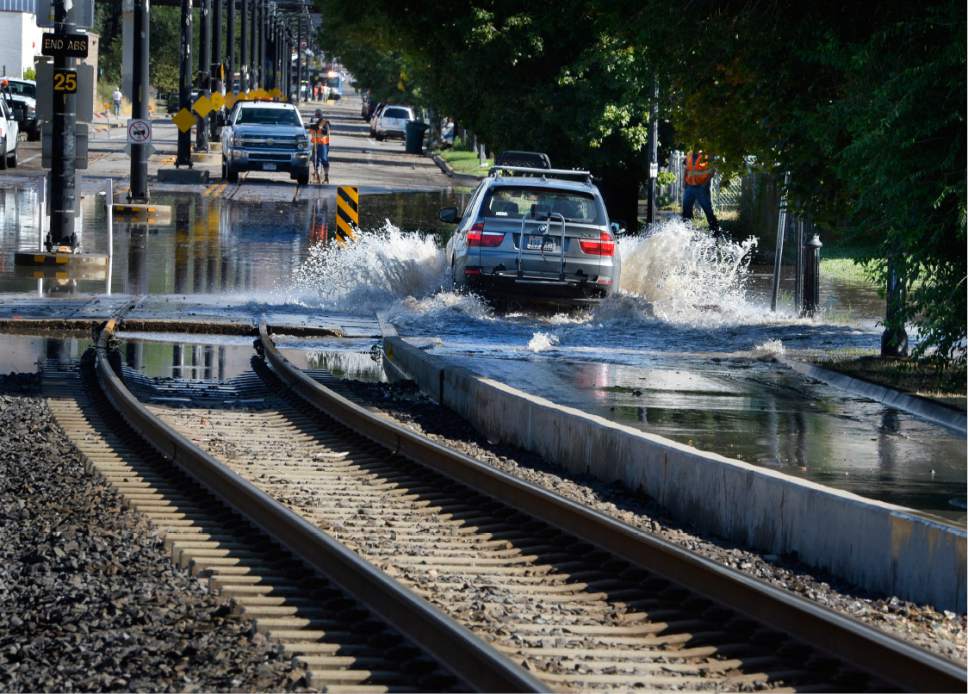 Scott Sommerdorf   |  The Salt Lake Tribune  
A determined motorist plowed through northbound 200W next to the flooded TRAX line. Northbound Main Line TRAX trains were prevented from leaving the Ballpark TRAX station due to flooding, Wednesday, July 26, 2017.