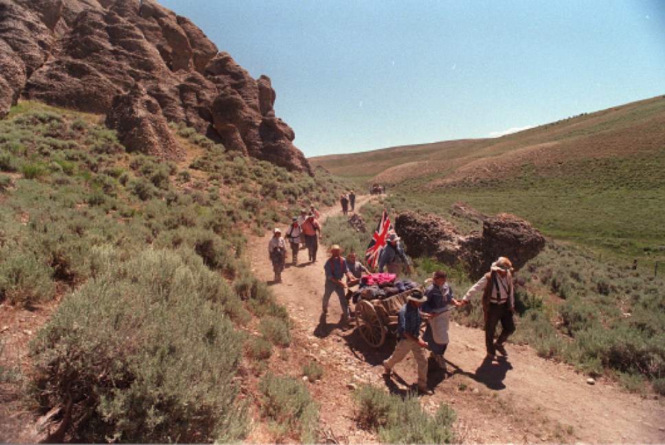 Rick Egan  | Tribune file photo 

Handcarts and walkers make their way around the Needles area of Wyoming on the 1997 Mormon Wagon Trail re-enactment.