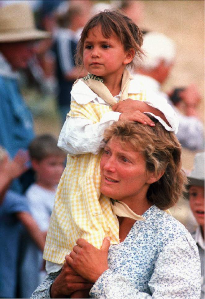 Rick Egan  | Tribune file photo 

Nanc' Adams is moved to tears as she carries her 4-year-old daughter, Jackie, on her shoulders as she enters the "This is the Place State Park" on July 22, 1997.