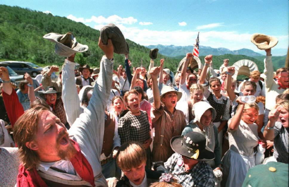 Rick Egan  | Tribune file photo 
Hand cart companies celebrate upon reaching the top of Big Mountain in Utah.