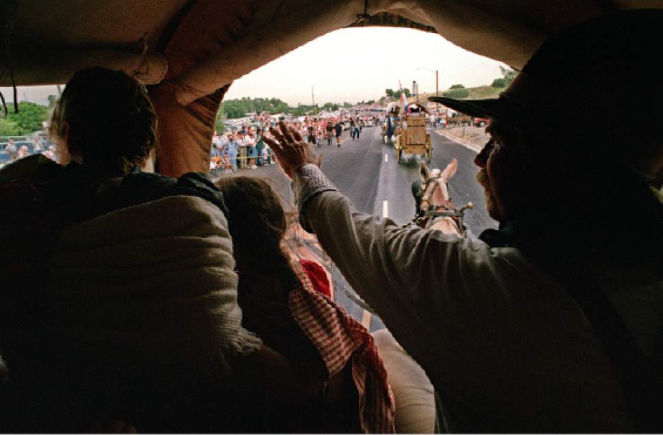 Rick Egan  |  The Salt Lake Tribune

Tom Whitaker (right) Midway, and his wife Linda (and Aleah (middle) wave to the crowd as the approach the This is the Place monument, at the mouth of Emigration canyon, Tuesday, July 22, 1997.
