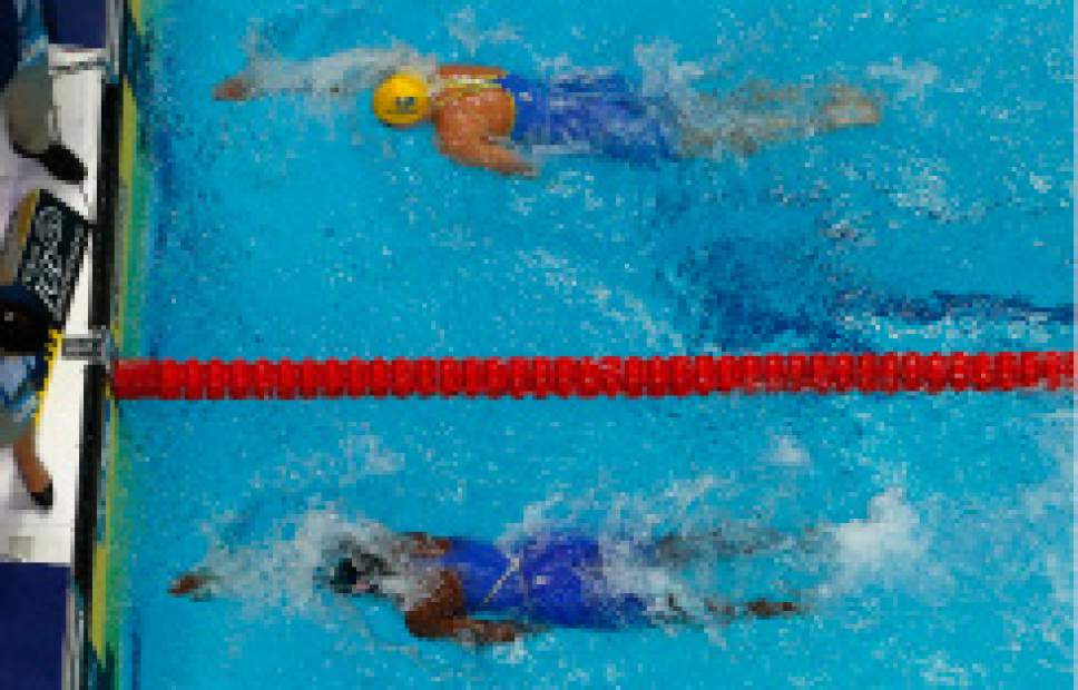 United States' Simone Manuel, bottom, wins the women's 100-meter freestyle final ahead of Sweden's Sarah Sjostrom, top, during the swimming competitions of the World Aquatics Championships in Budapest, Hungary, Friday, July 28, 2017. (AP Photo/Michael Sohn)