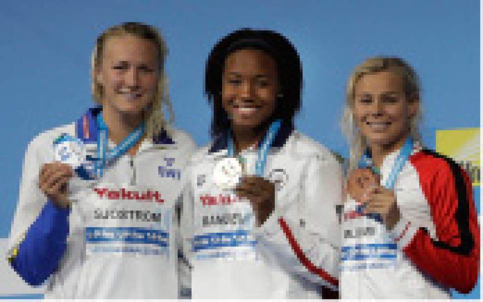 United States' gold medal winner Simone Manuel is flanked by Sweden's silver medal winner Sarah Sjostrom, left, and Denmark's bronze medal winner Pernille Blume, right, after the women's 100-meter freestyle final during the swimming competitions of the World Aquatics Championships in Budapest, Hungary, Friday, July 28, 2017. (AP Photo/Petr David Josek)