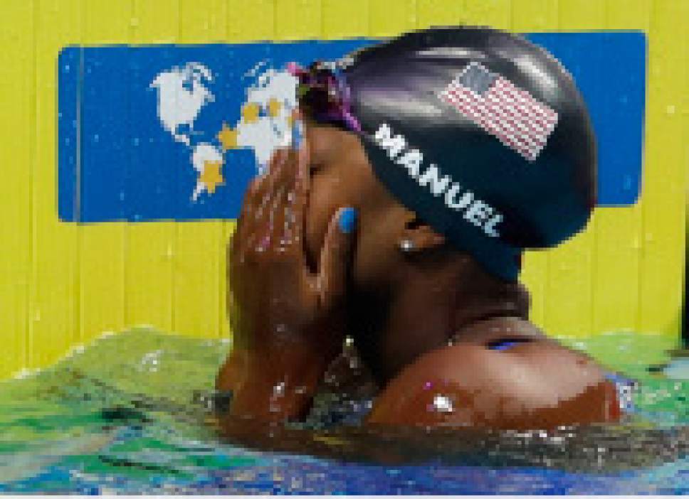 United States' Simone Manuel cover her face after winning the gold medal in the women's 100-meter freestyle final during the swimming competitions of the World Aquatics Championships in Budapest, Hungary, Friday, July 28, 2017. (AP Photo/Petr David Josek)