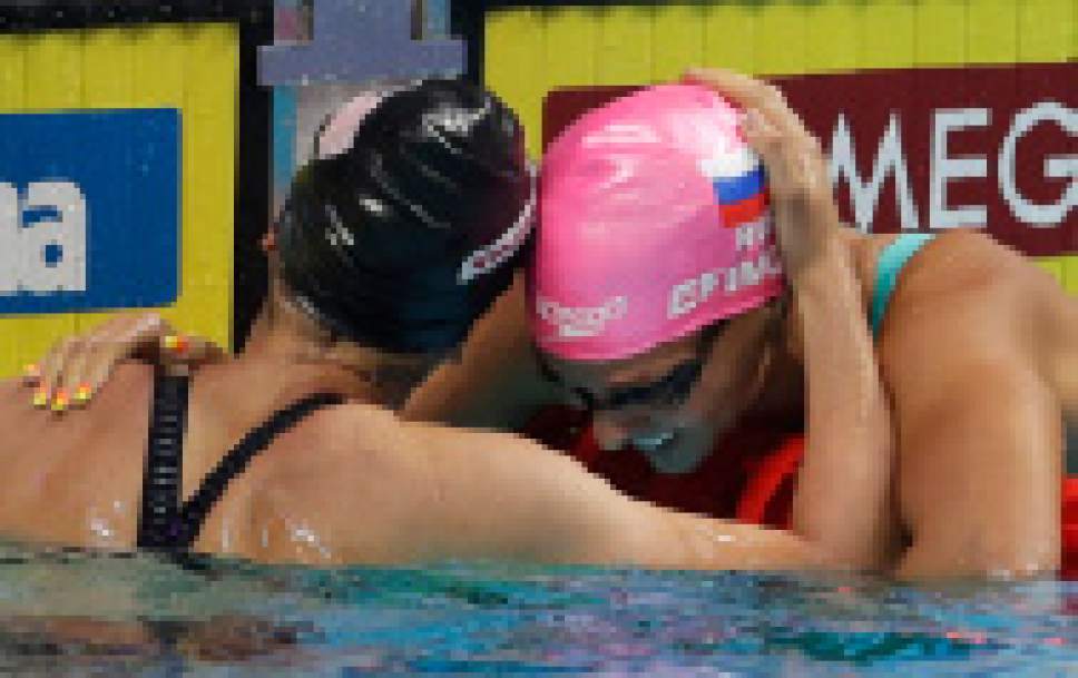Russia's Yuliya Efimova, right, is congratulated by United States' silver medal winner Bethany Galat after winning the gold medal in the women's 200-meter breaststroke heat during the swimming competitions of the World Aquatics Championships in Budapest, Hungary, Friday, July 28, 2017. (AP Photo/Petr David Josek)