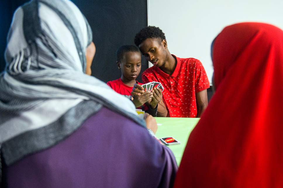 Chris Detrick  |  The Salt Lake Tribune
Promise Prevention Specialist Said Mohamed plays cards with Abdi Mahad, 7, at the Hser Ner Moo Community Center in South Salt Lake on Tuesday, July 18, 2017.