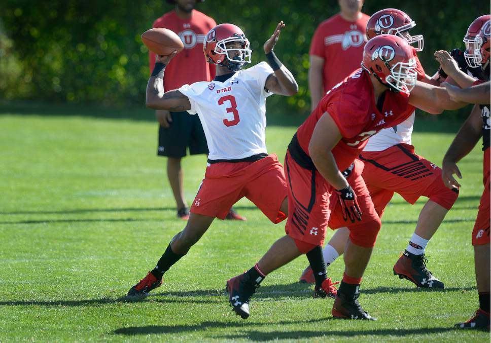 Scott Sommerdorf   |  The Salt Lake Tribune  
Utah QB Troy Williams passes behind protection from his offensive line during the first day of Utah fall football camp, Friday, July 28, 2017.