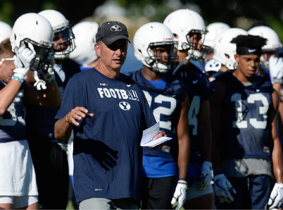 Francisco Kjolseth | The Salt Lake Tribune
BYU football offensive coordinator and quarterback coach Ty Detmer works with the team during preseason training camp on Thursday, July 27, 2017, in Provo.