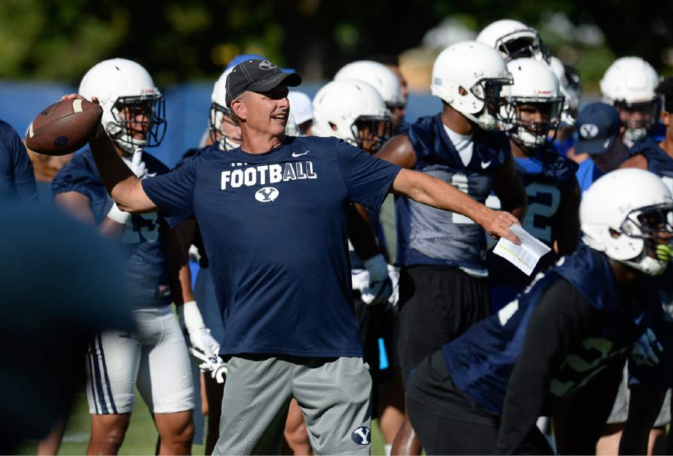 Francisco Kjolseth | The Salt Lake Tribune
BYU football offensive coordinator and quarterback coach Ty Detmer works with the team during preseason training camp on Thursday, July 27, 2017, in Provo.