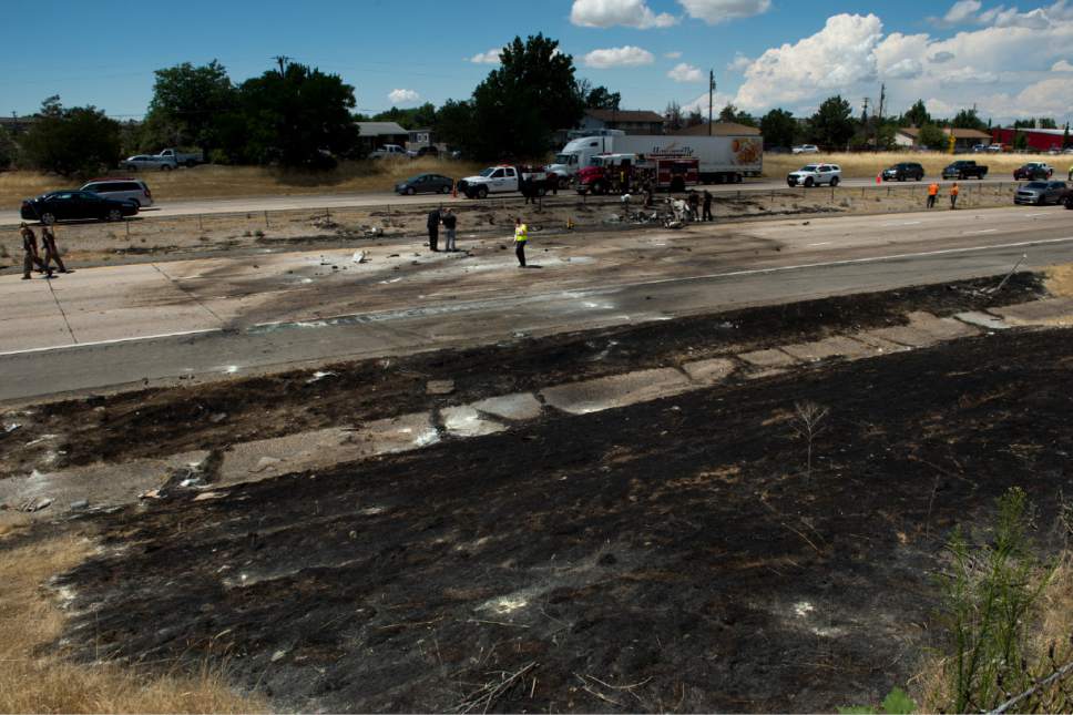 Rick Egan  |  The Salt Lake Tribune
Police investigate the plane crash that killed four people in the median of I-15 freeway Wednesday, July 26, 2017. The crash closed the freeway to northbound traffic.