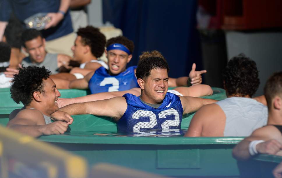 Francisco Kjolseth | The Salt Lake Tribune
BYU football players cool off following their first preseason training camp on Thursday, July 27, 2017, in Provo.