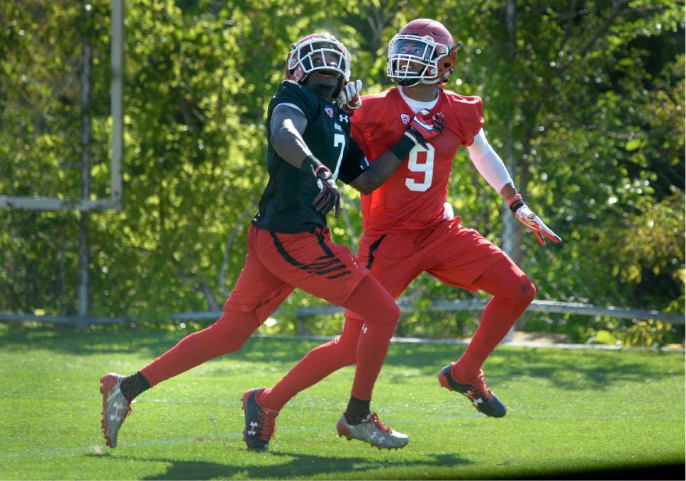 Scott Sommerdorf   |  The Salt Lake Tribune  
WR Darren Carrington II looks back for the ball as he battles with DB Jaylon Johnson during the first day of Utah fall football camp, Friday, July 28, 2017.