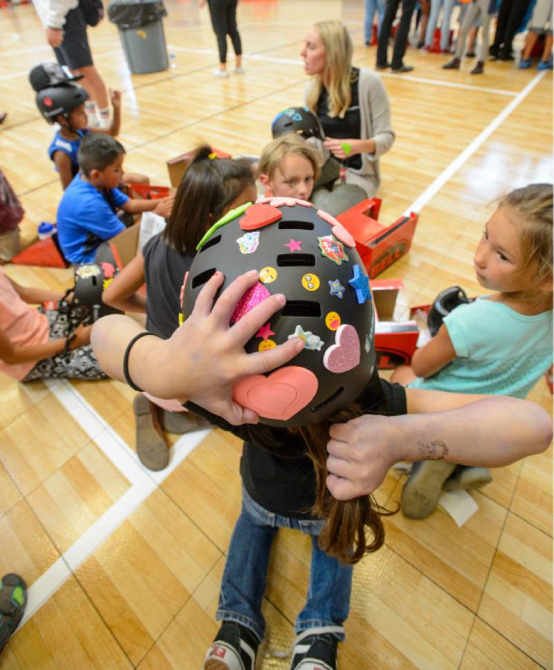 Steve Griffin  |  The Salt Lake Tribune

Alexy Zepeda, 6, adjusts her pony tail as she wears her new bike helmet at the Lied Boys & Girls Club in Salt Lake City Friday July 28, 2017.  UnitedHealthcare donated helmets to help encourage kids and families to participate in the Tour of Utah kids' events. Club youth received the helmets and a helmet-fitting from UnitedHealthcare Pro Cycling Team members, as well as a lesson in helmet and bike safety.