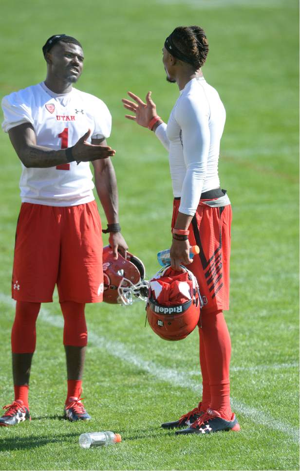 Scott Sommerdorf   |  The Salt Lake Tribune  
Utah QB Tyler Huntley, left, meets with new Utah WR Darren Carrington II after the first day of Utah fall football camp, Friday, July 28, 2017.  during the first day of Utah fall football camp, Friday, July 28, 2017.