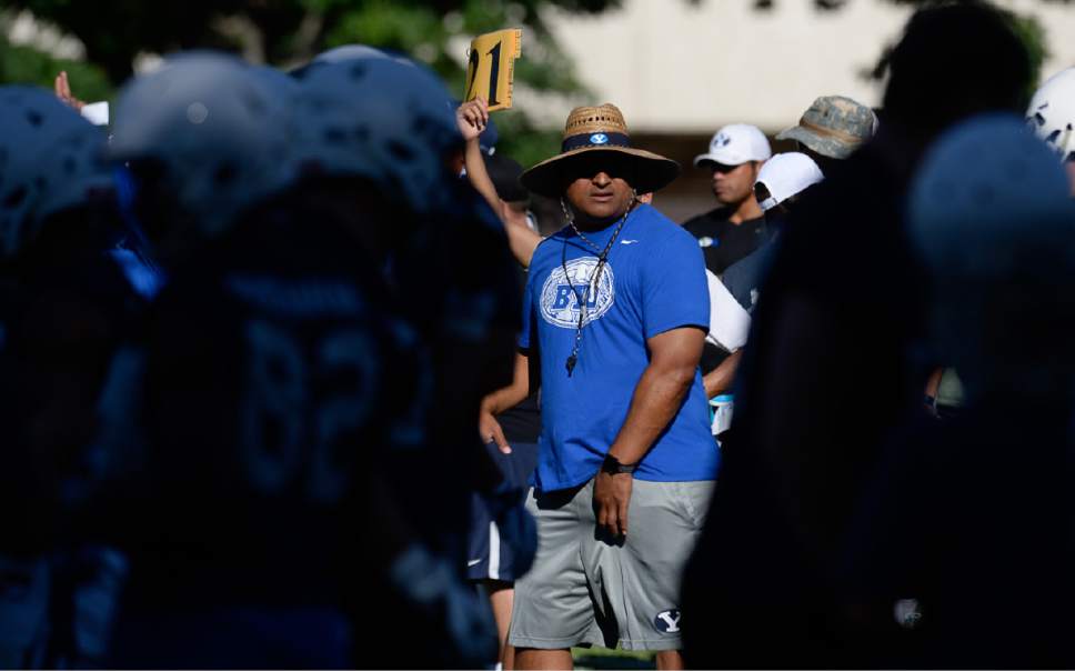 Francisco Kjolseth | The Salt Lake Tribune
BYU football coach Kalani Sitake, center, begins preparations for the season with preseason training camp on Thursday, July 27, 2017, at their practice field in Provo.