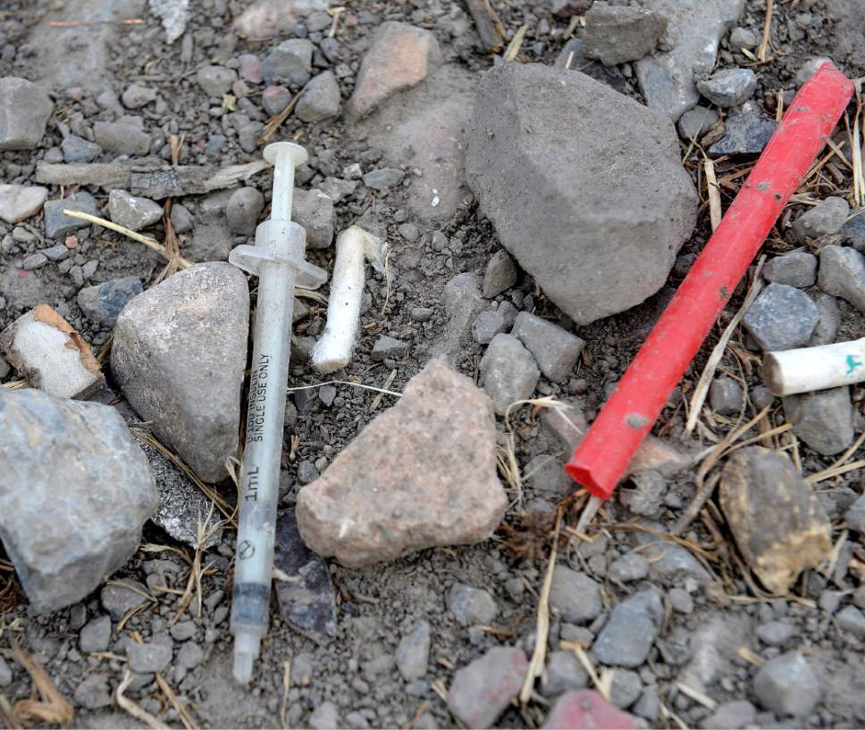 Al Hartmann  |  The Salt Lake Tribune
Used hypodermic needle used to shoot heroin and a straw used to inhale burning heroin from tinfoil in the Rio Grande neighborhood Wednesday July 19.