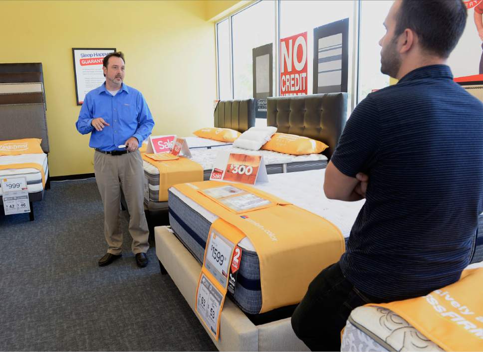 Al Hartmann  |  The Salt LakeTribune
Assistant Manager Rory Snyder shows a shopper mattress options in the  showroom at Mattress Firm in Draper. Mattress Firm is one of the retailers that uses Progressive Leasing to finance some of its sales.
