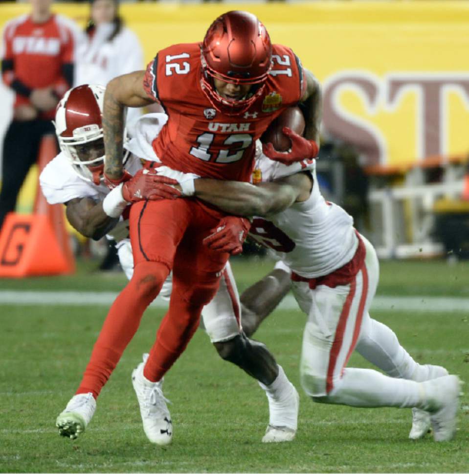 Steve Griffin / The Salt Lake Tribune

Utah Utes wide receiver Tim Patrick (12) gets wrapped up by the Indiana defense after catching a slant pass during the Foster Farms Bowl at Levi's Stadium in Santa Clara California  Wednesday December 28, 2016.
